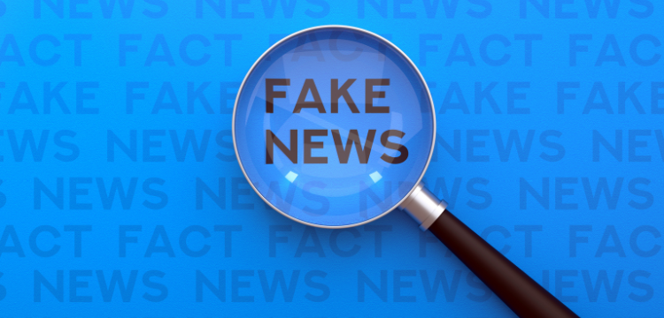 Writing "Fake News" under a magnifying glass